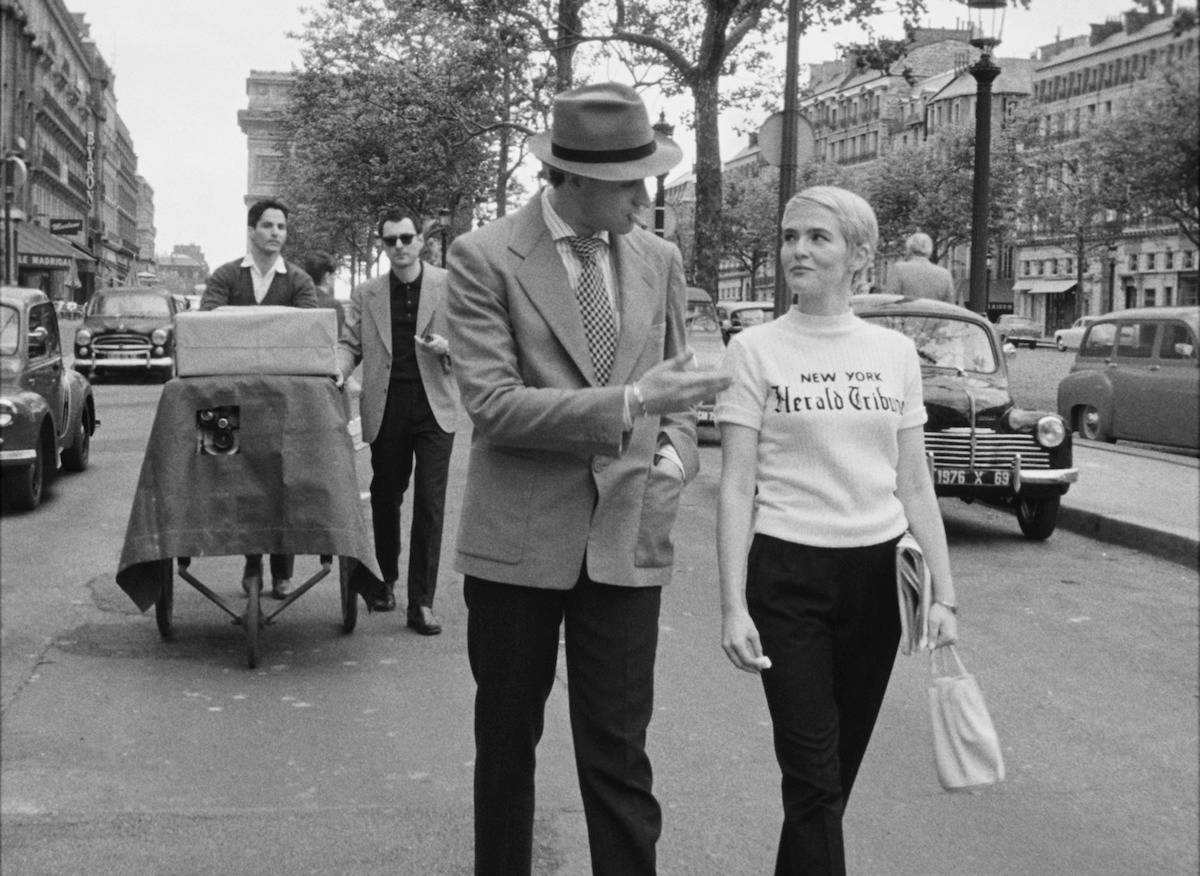 Man and woman walking down a Paris street in 2025